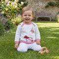 Baby wearing Fairy Knitted Jumper in garden