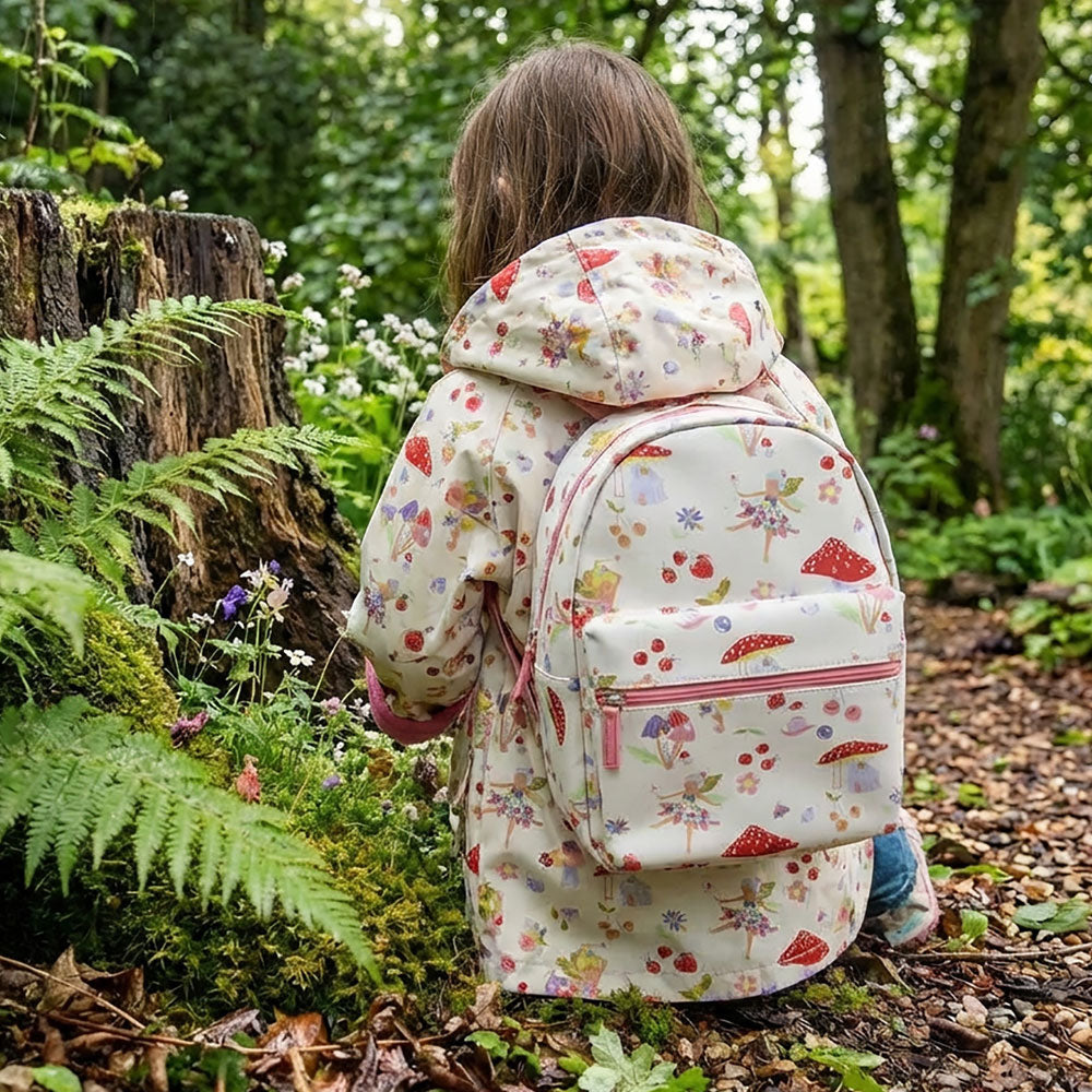 Child wearing Fairy Print Backpack in woodland