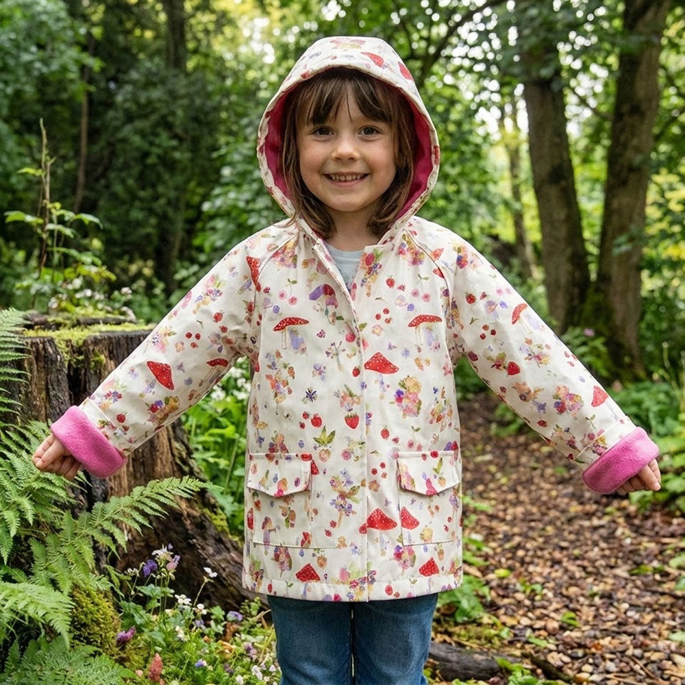 Girl wearing Fairy Print Raincoat outdoors in woodland setting
