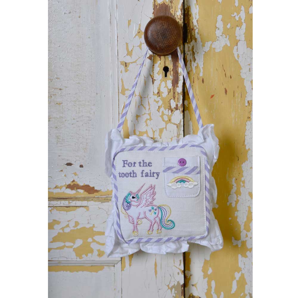 Unicorn Tooth Fairy Cushion hanging on a vintage door handle